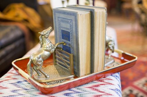 Red laminate tray with vintage books and horse bookends 