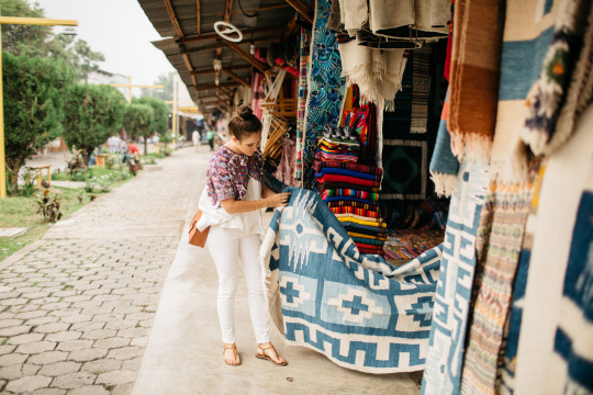 Mara Collective founder Sarah Contrucci Smith checks out blue woven textile.