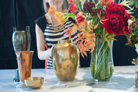 Vintage vases for holiday floral arrangements on white marble countertop