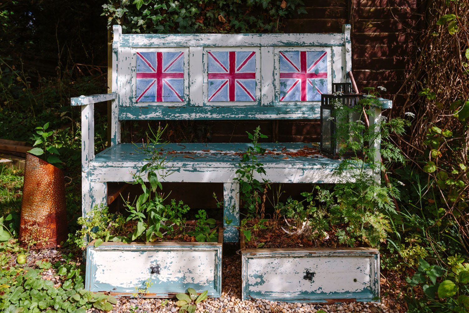 Vintage, rustic painted bench with British flags on chairish 