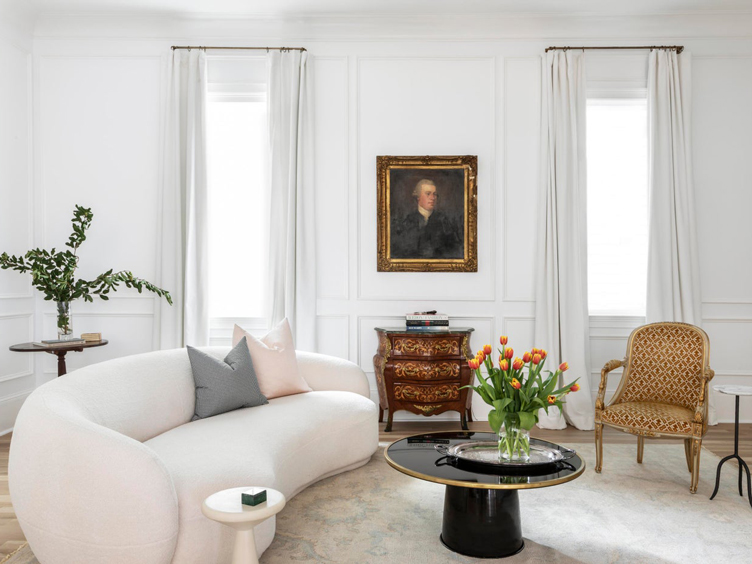 Designer Sherry Shirah paired 70's curved sofa and black with a sleek round coffee table and ornate accent chair and side table.