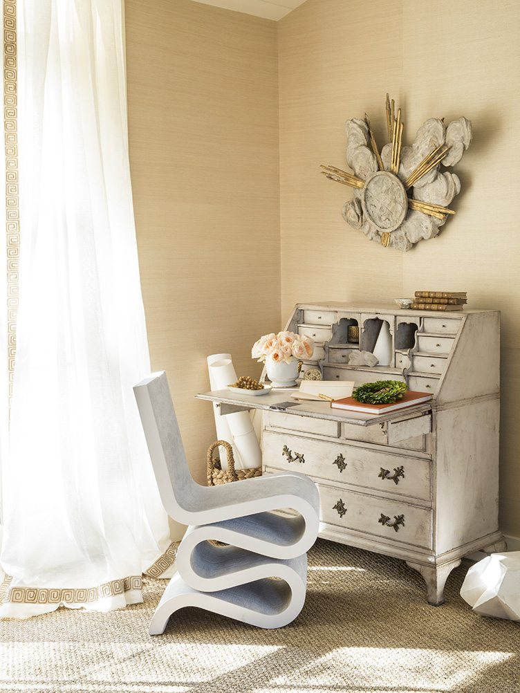 The living room at the Hirai home in Redwood City, CA pairs a traditional white secretary desk with a modern chair.