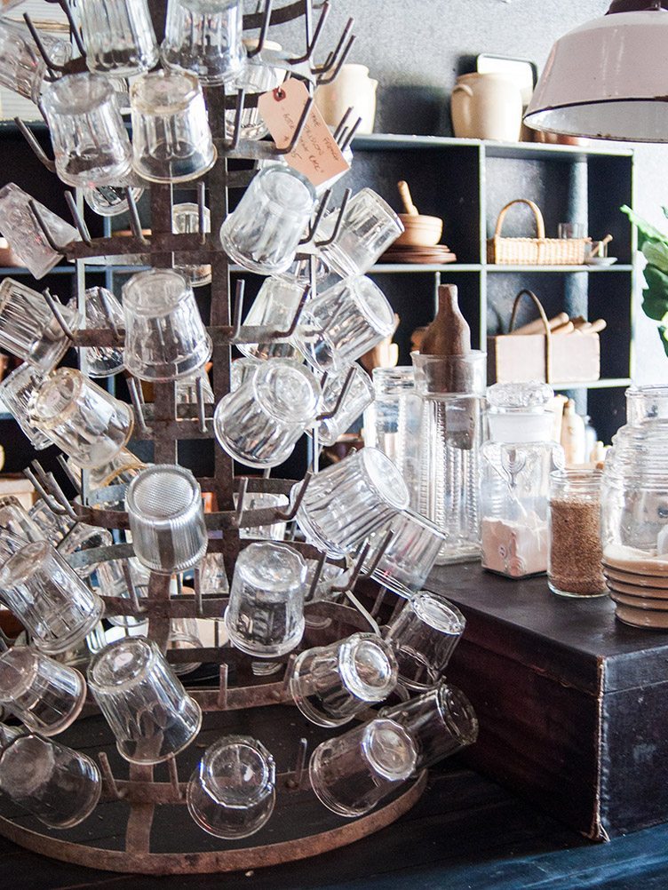 Collection of Vintage Glassware on metal display with jars and baskets