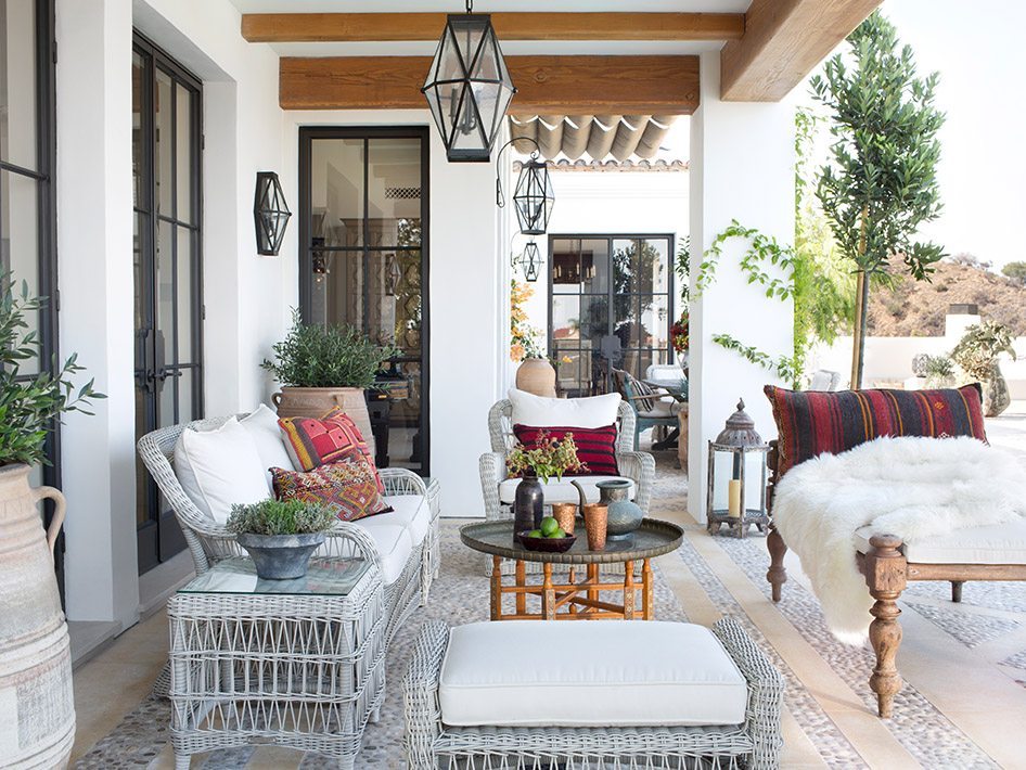 Gray woven sofa, armchair with assorted designs on backyard porch