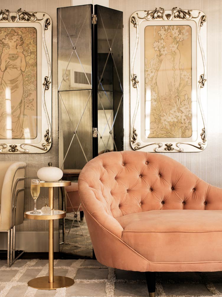 Art nouveau sofa, and art deco accent chair in front of reflective folding screen