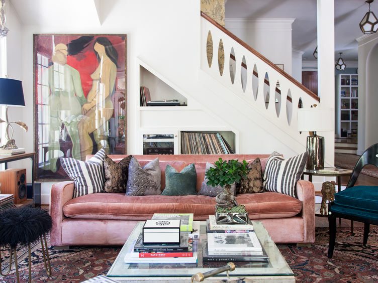 Shabby Chic Living Room With Velvet Pink Sofa, Vintage Textile Rug and Large Nude Hanging Art.