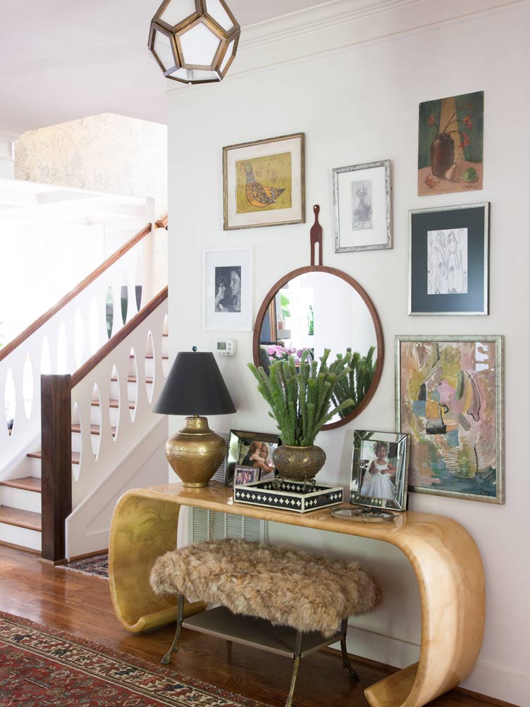 Shabby Chic Entryway with Vintage Gallery Wall and Wooden Side Table on Chairish.