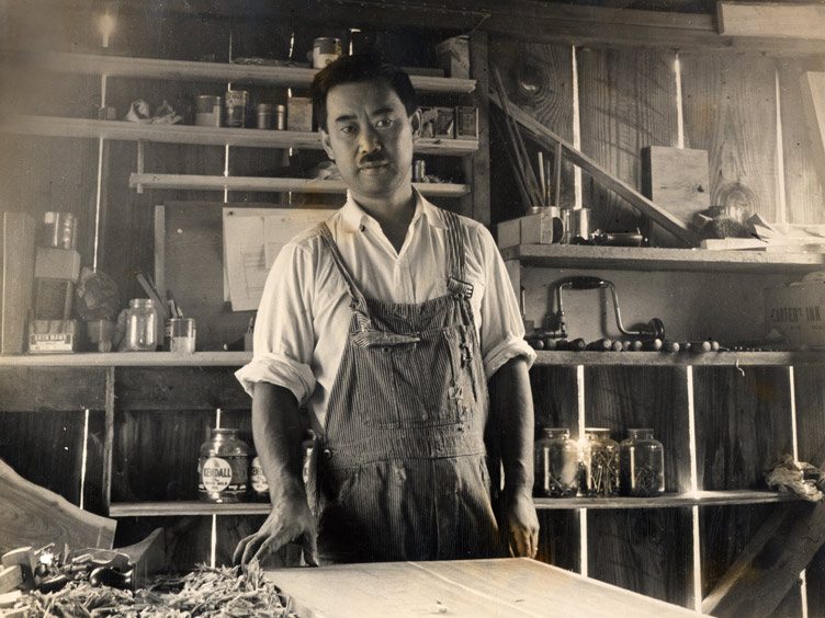 Iconic Furniture Maker George Naskashima poses in his woodworking studio