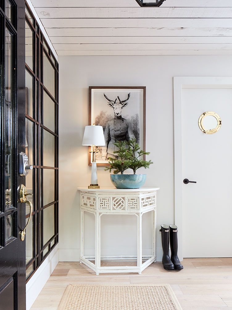 Traditional Home Entryway with White Side Table and Unique Hanging Art.