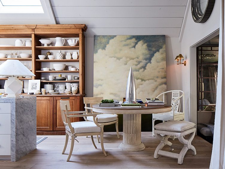 Shabby Chic Kitchen With Large Wooden Shelving and Large Painting of Clouds. 