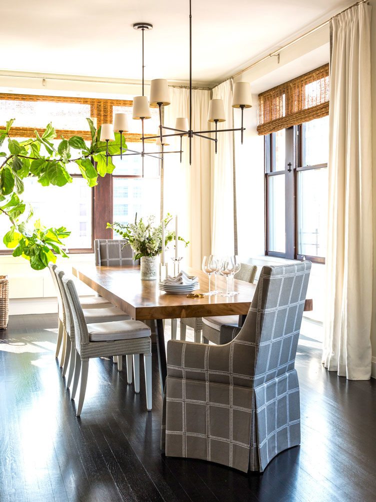 Striped pattern chair set, and wooden dining room table, under contemporary chandelier
