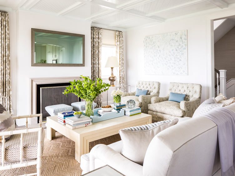 Bright living room with deco-style coffee table, bamboo accent chair, and neutral tones