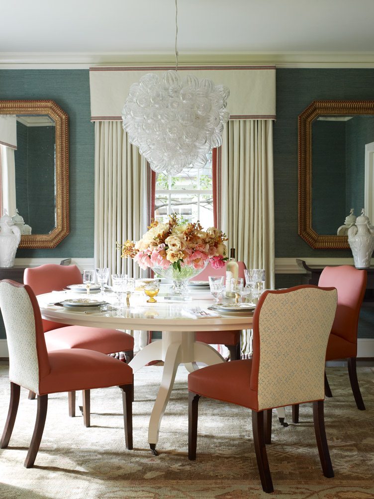 Traditional Dining Room Table with Pink Leather Dining Chairs and Large Glass Chandelier.