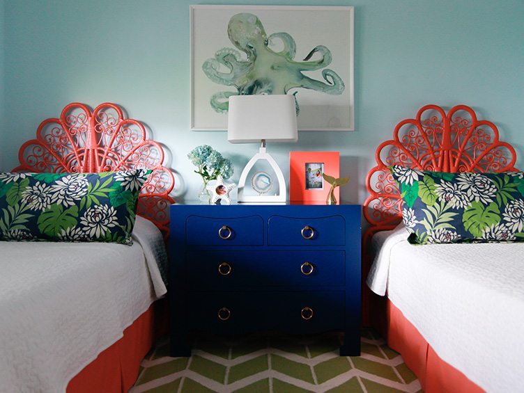 Twin Beds with matching Orange Headboards and Floral Decorative Pillows.