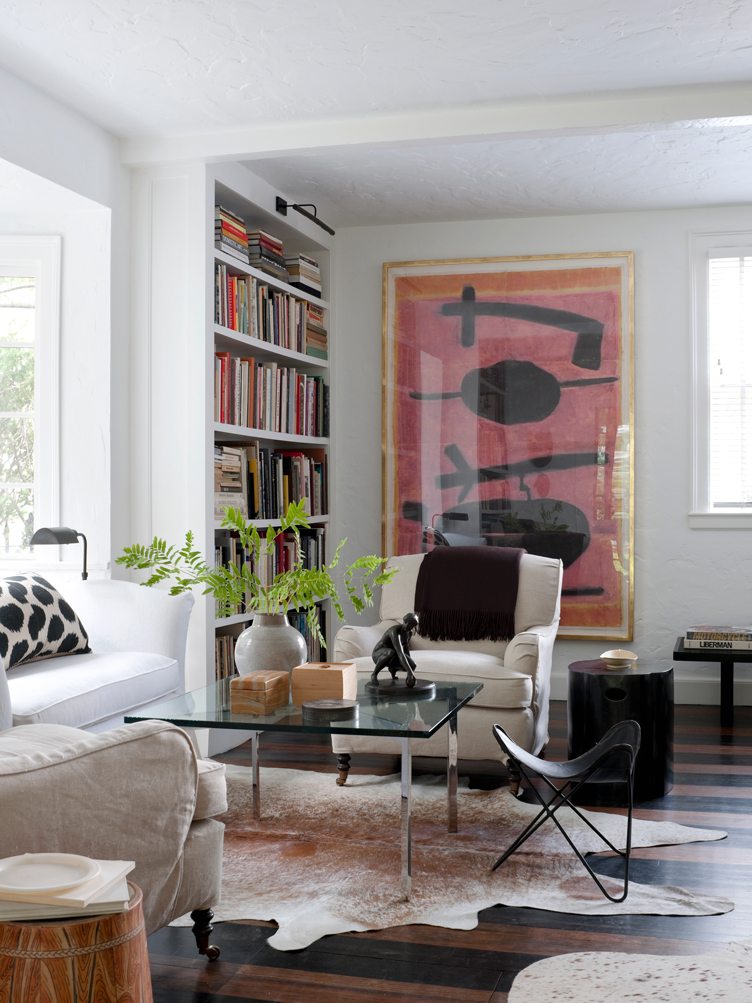 Contemporary Living Room with Large Bookshelf and Cowhide Rug.