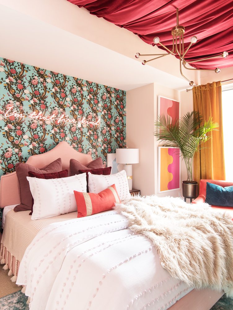 Pink Master Bedroom with Pink Neon Lit Cursive Letters and Pink Drapery on the Ceiling.