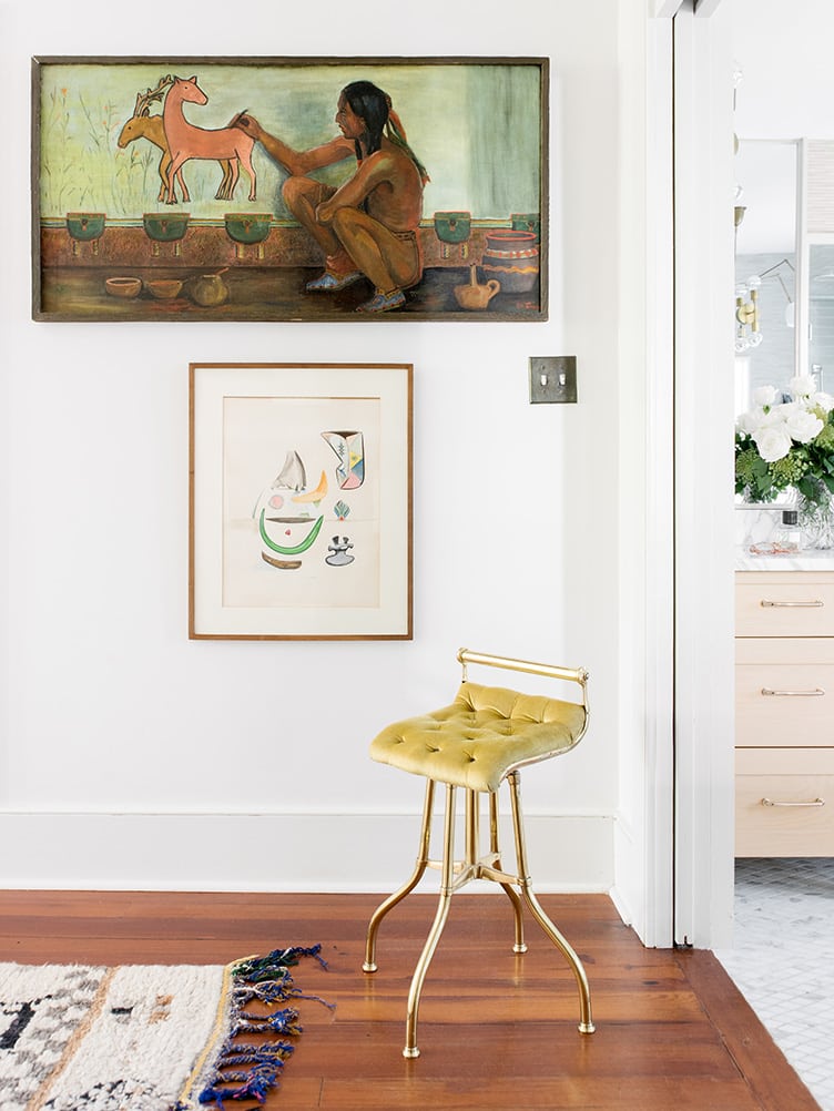 Master Bedroom with Vintage Brass Stool and Large Vintage Paintings on Chairish.