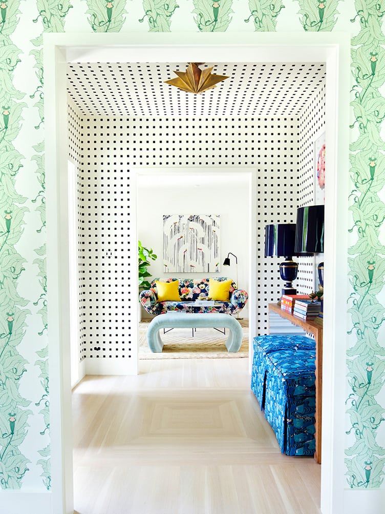 Eclectic Home Entryway with Clashing Wallpaper and Bronze Hanging Light.