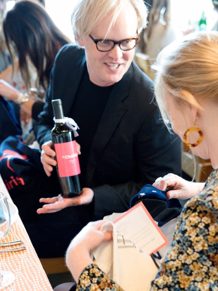 Grant Gibson holds his Chairish bottle of wine at San Francisco design luncheon