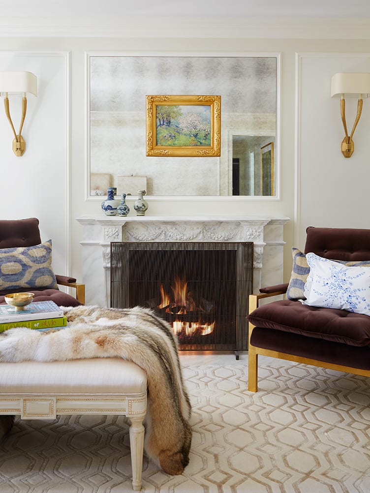 Elegant Living Room With Marble Fireplace and Twin Brown Velvet Armchairs with Fur Throw Blanket.