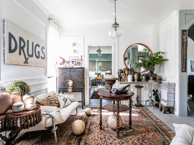 Eclectic Living Room with "DRUGS" Artwork and assortment of Clay Pots and Busts.