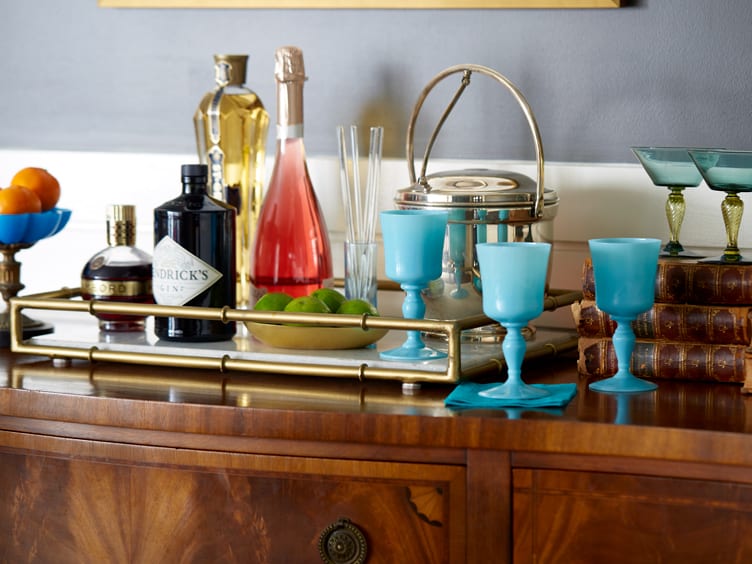 Antique brass tray with bar materials and blue jadeite wine glasses.