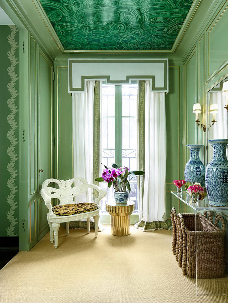 Green paneled room, malachite wallpaper ceiling, white plaster chair, blue and white urns, seagrass basket