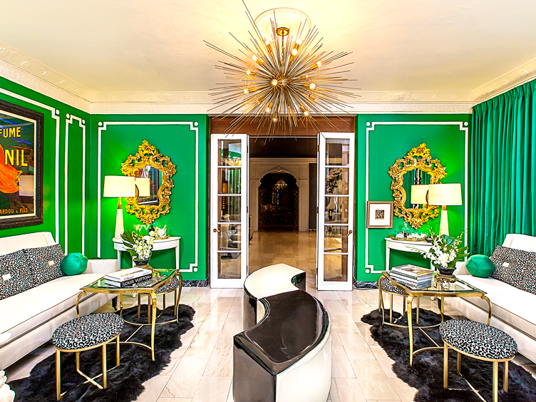 Deco-inspired living room with green walls, ornate mirrors, and black and white cheetah accents.