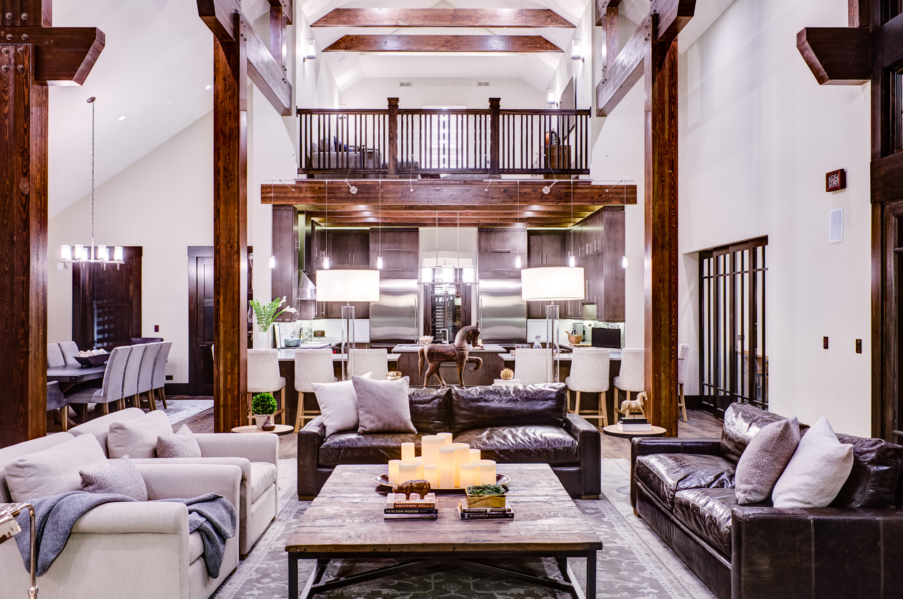 Private residence by studio m interiors with wood beams and modern kitchen and leather sofas