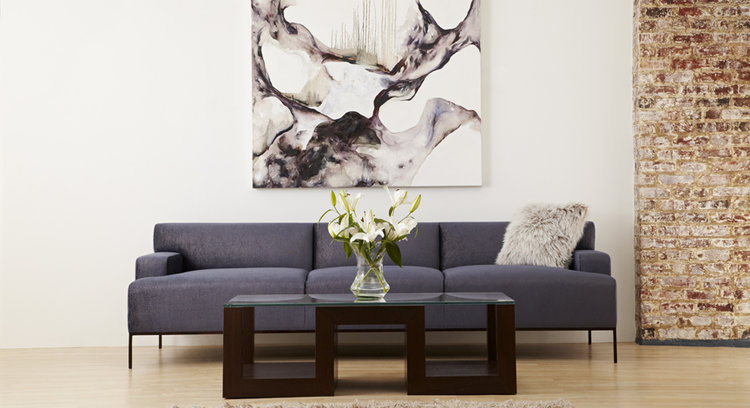 Traditional living room with dark gray sofa and wood and glass coffee table