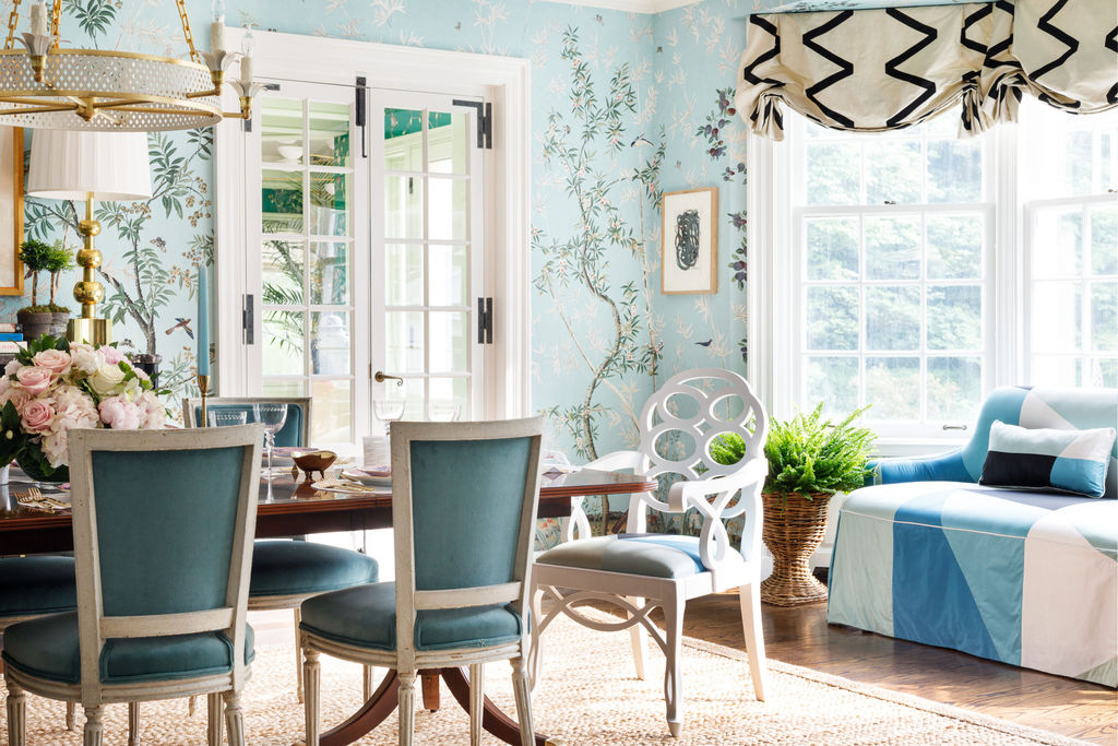 Blue dining room with geometric blue couch and wicker planter