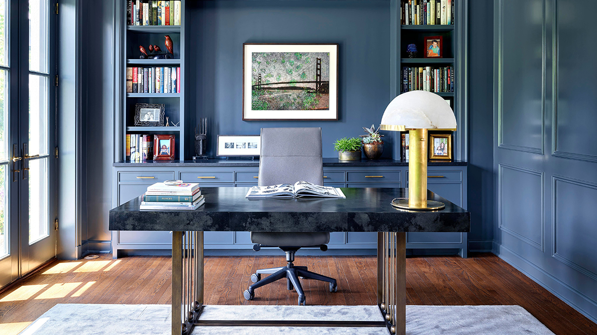 Blue home office with grand marble desk and gold table lamp on Chairish