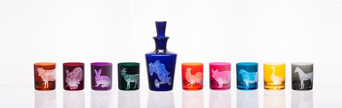 Multi-colored glass decanter and glasses with animal motifs 