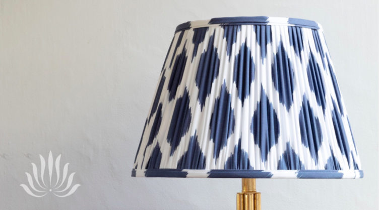 Blue and white patterned pleated lampshade with brass base