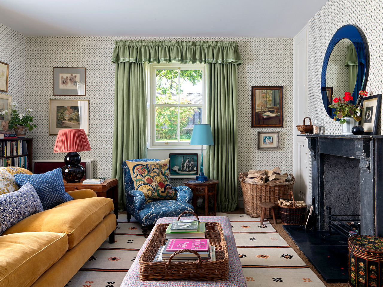 Eclectic living room with yellow velvet sofa and black and white wallpaper 