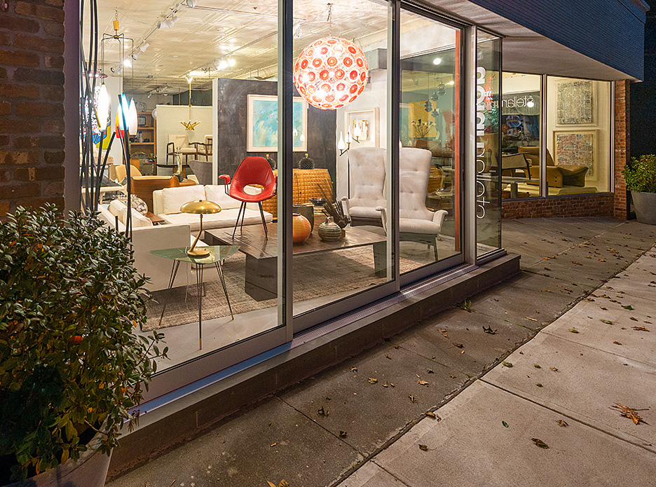 Looking into the window of Stellar Union with vintage, midcentury furniture.