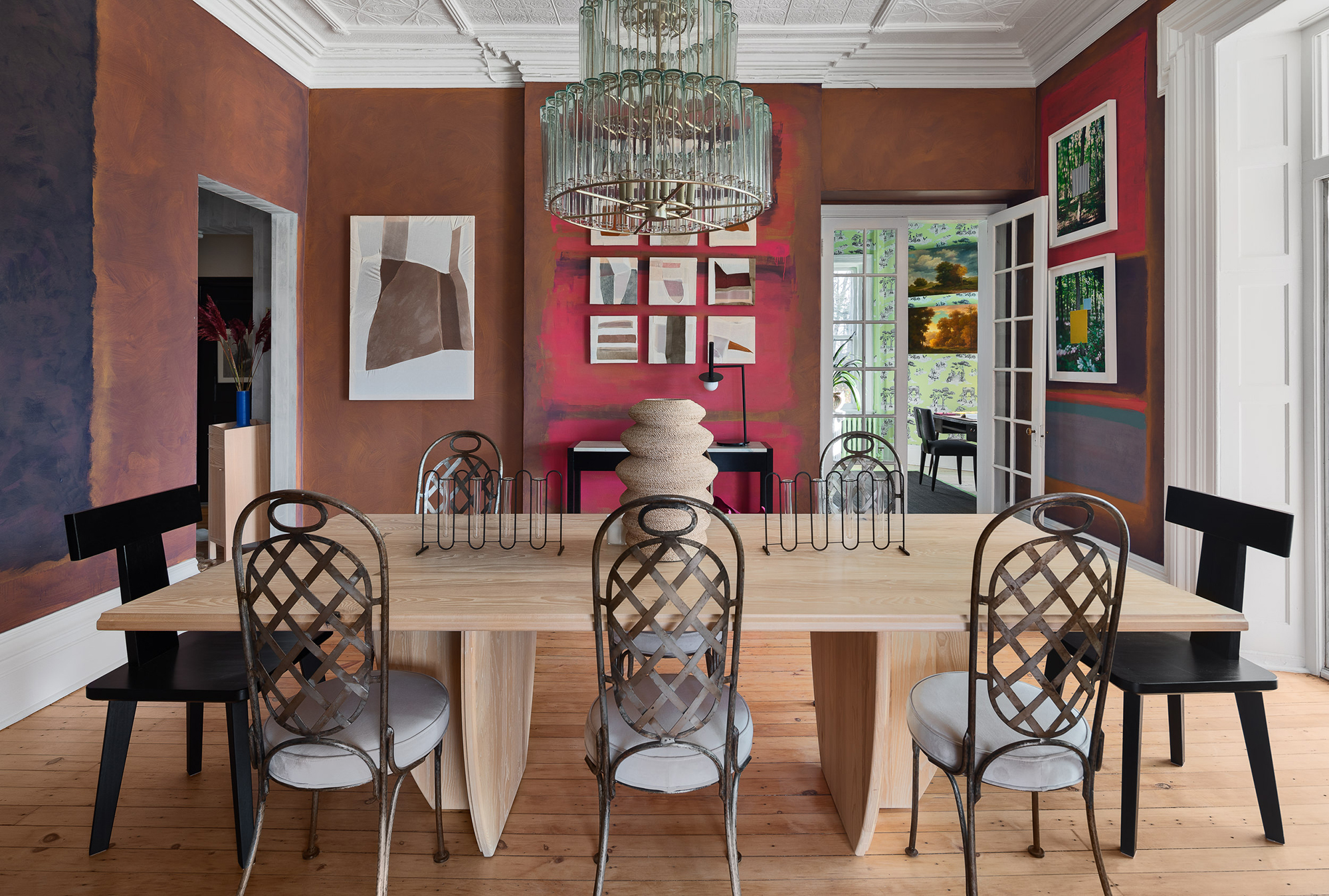 Dining room with Rothko-inspired wall paper, modern wall art, and large wood table with metal dining chairs.