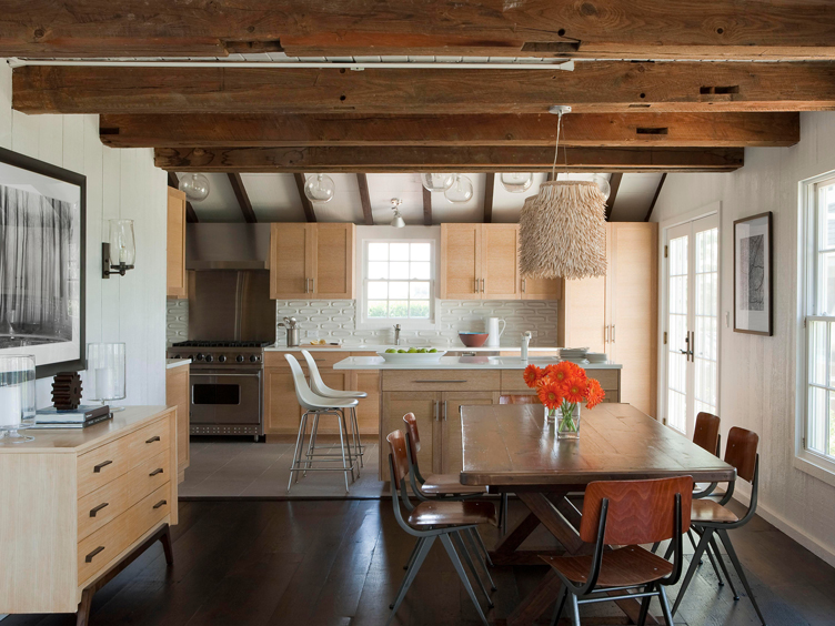 The mid-century inspired wood chairs balance the wood ceiling beams in this all-wood kitchen.