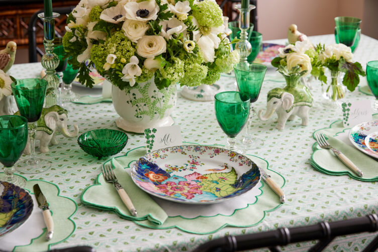 Allison Speer's green tablescape with scalloped linens, clear glassware, and floral centerpiece.