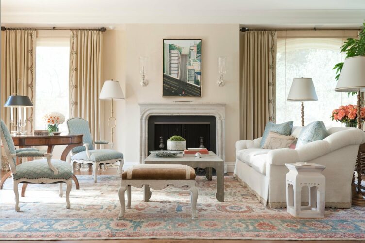 Traditional living room with Louie-style blue armchairs and large woven rug