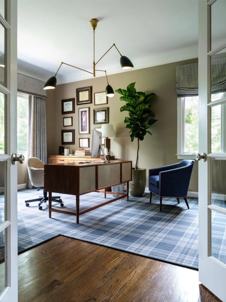 Iantha Carley used a sputnik pendant chandelier in this home office filled with a vintage desk, blue barrel chair, and vintage picture frames 