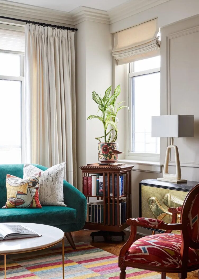 Traditional modern eclectic living room with a wood  revolving library bookcase used as a plant stand