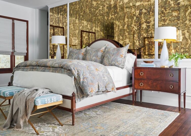 Master Bedroom Featuring Antique Mirror Wall and upholstered gold and light blue x-benches