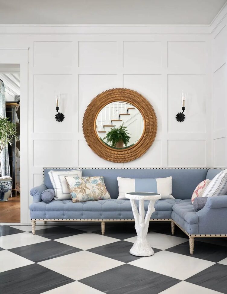 Neo Georgian entry with blue gray sofa and white faux bois side table